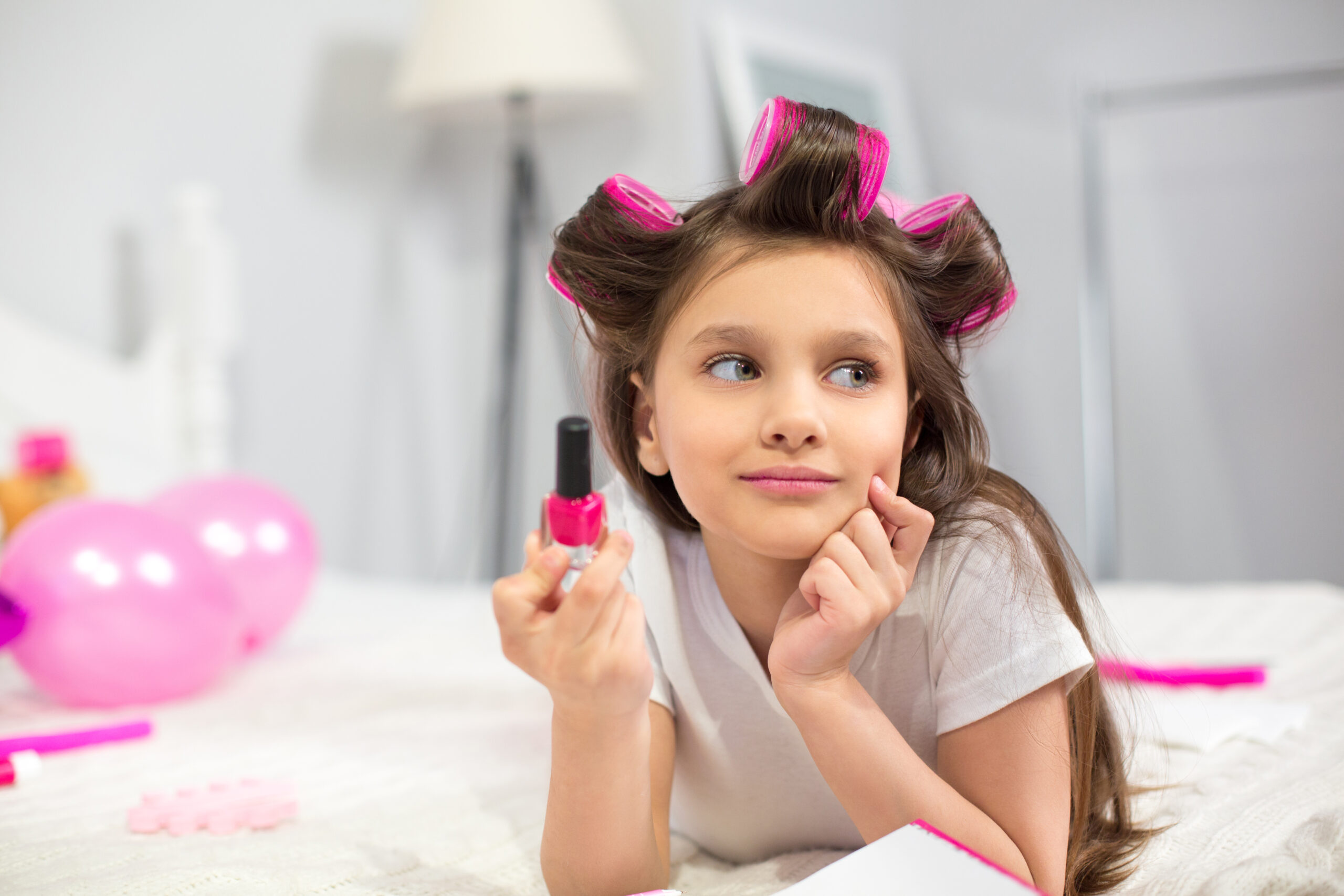 Cute Preschooler Laying White Blanket Holding Nail Polish
